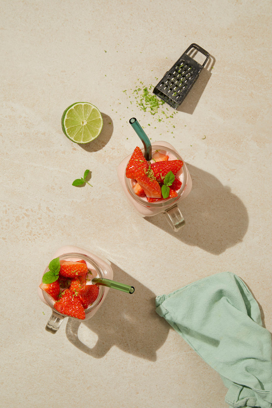 To røde drinker med sugerør med lime og rivhjern