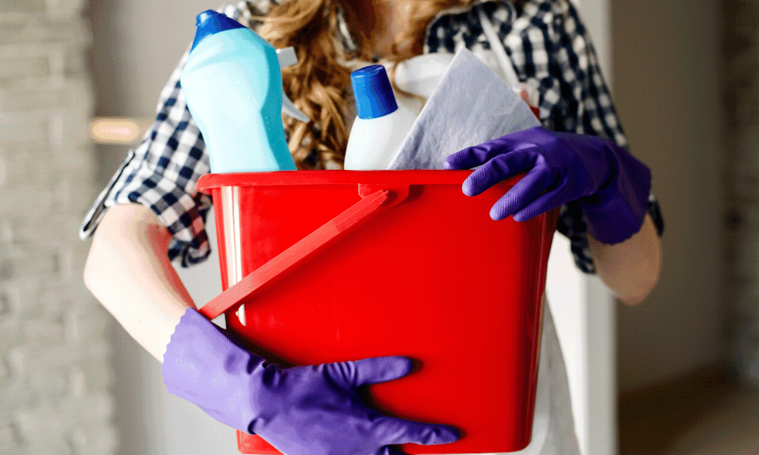 Kvinne holder bøtte med vaskemidler