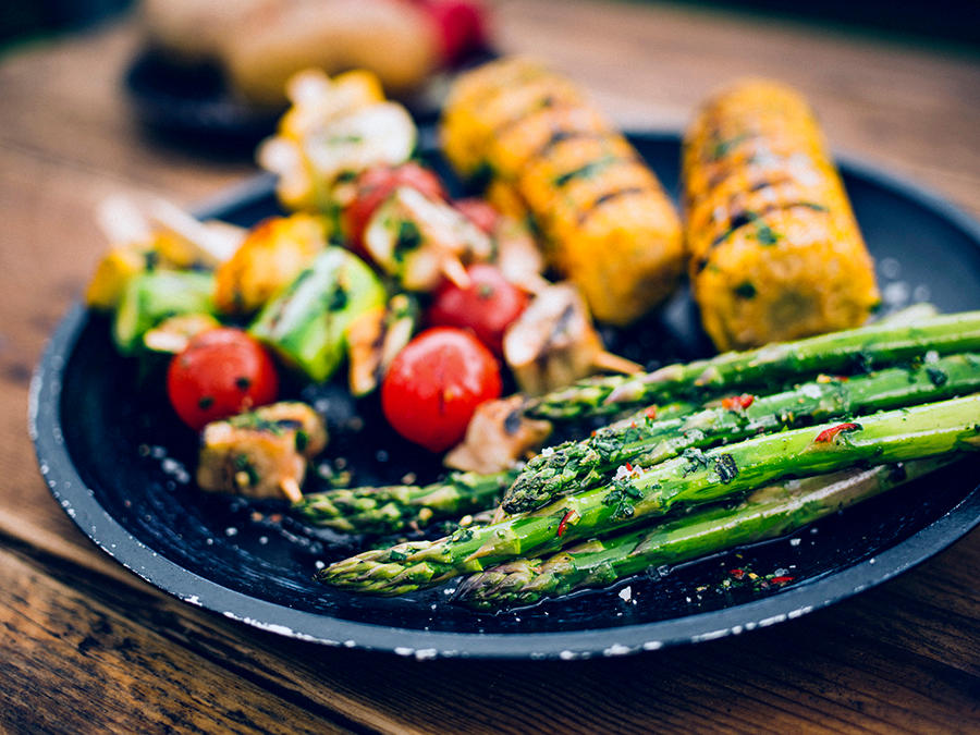 Fat med grillet asparges, grillede maiskolber og grillspidd med tomater og sopp. 