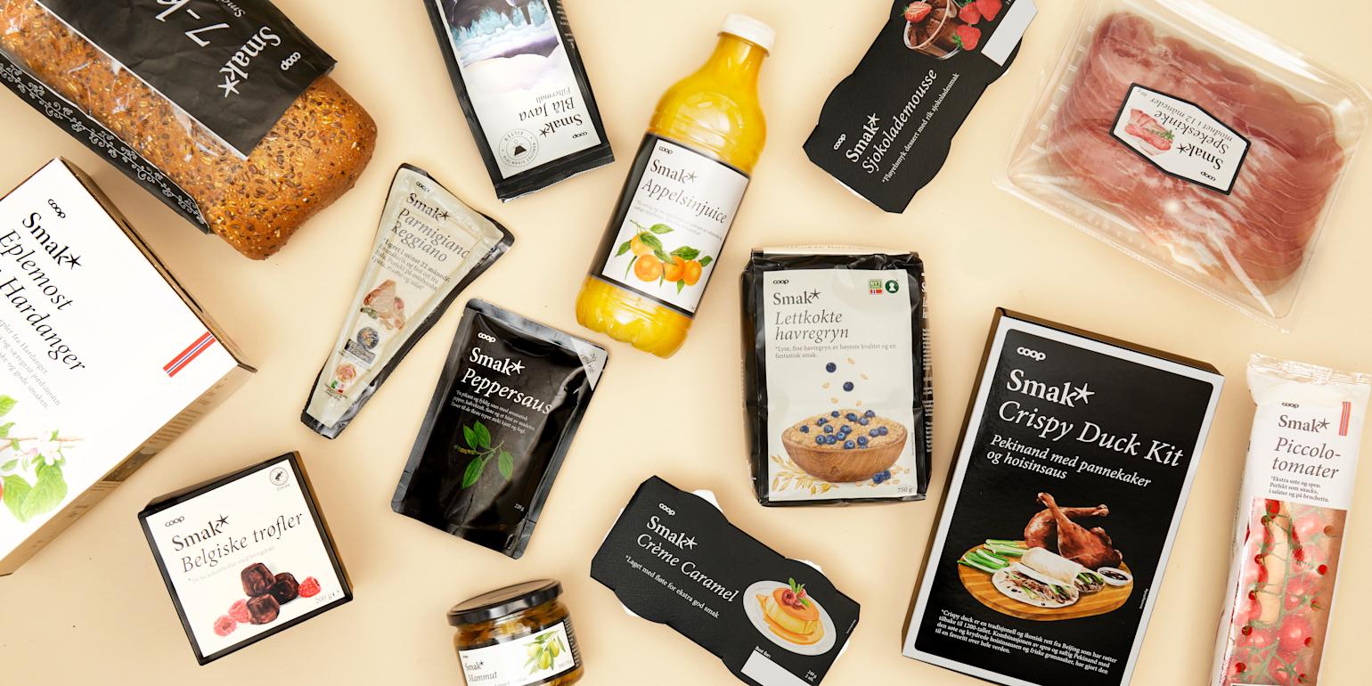 En bordflate fylt med ulike Smak-produkter som crispy duck, juice, brød, ost og mer.